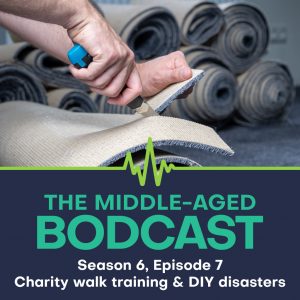 Close-up of hands cutting carpet with a utility knife, with rolls of carpet in the background. Overlaid text reads: "The Middle-Aged Bodcast: Season 6, Episode 7 - Charity walk training & DIY disasters."